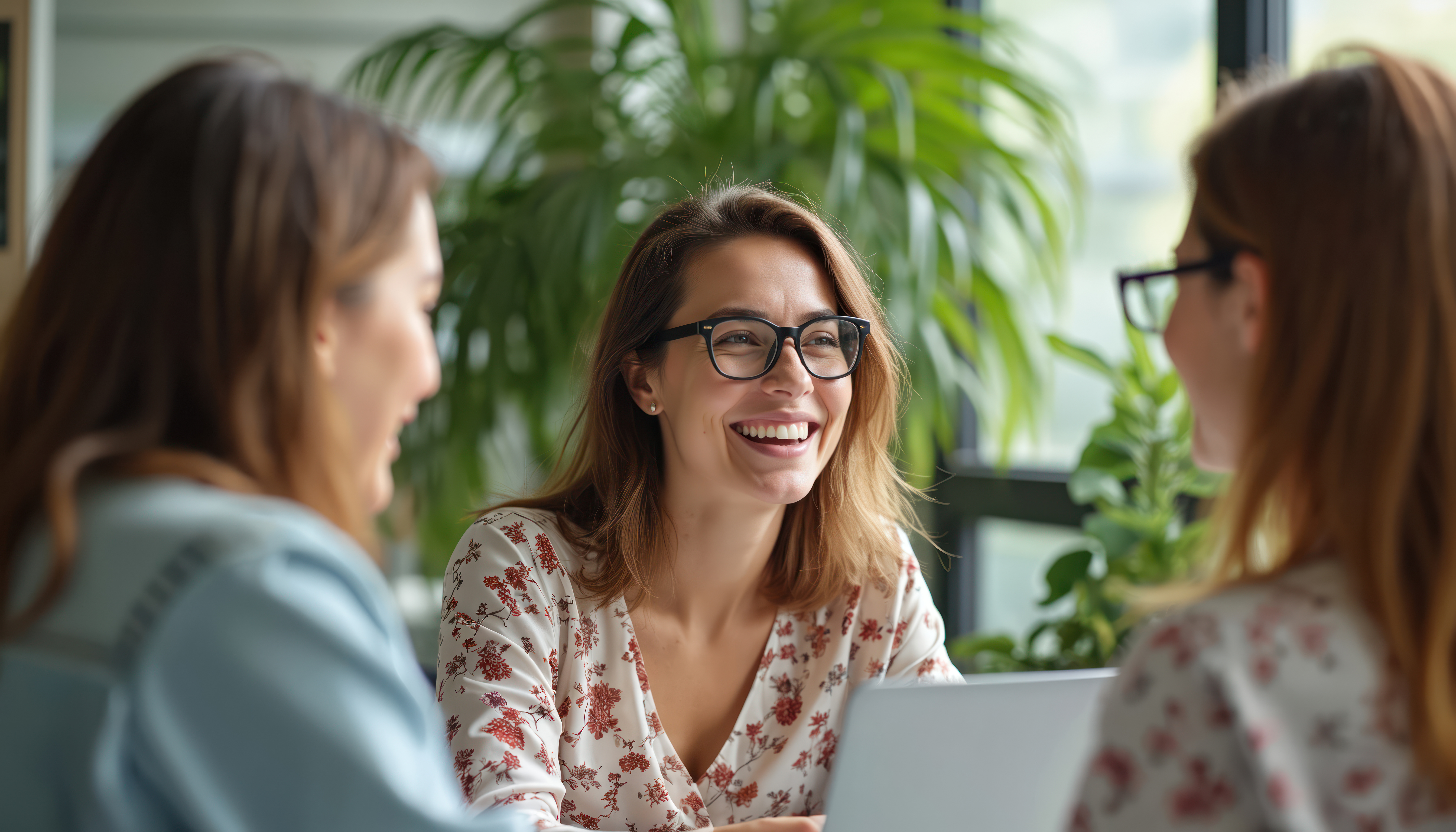 three-women-laughing-in-office-meeting.jpeg