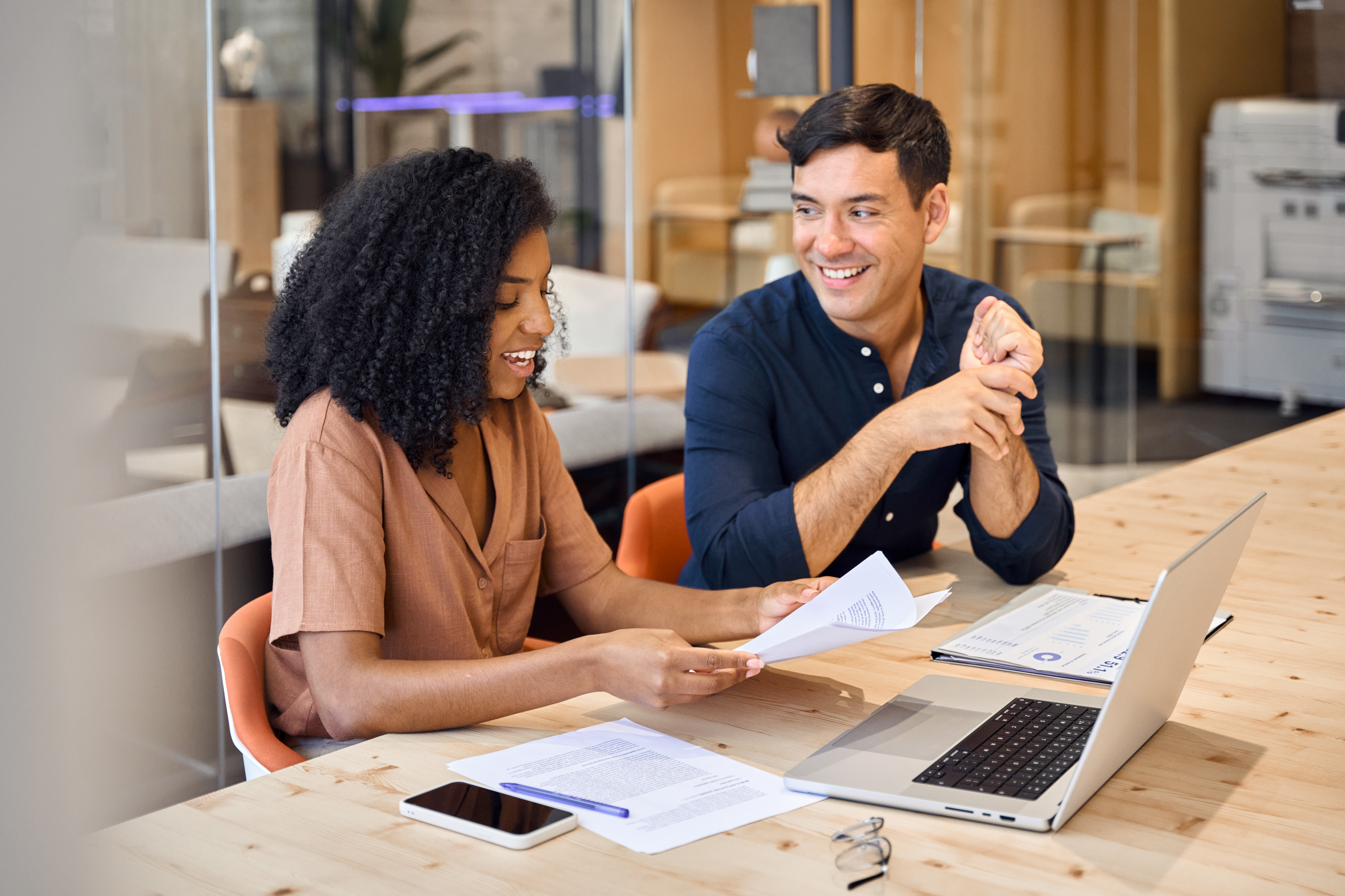two-colleagues-smiling-and-reviewing-documents-with-laptop.jpeg (2)