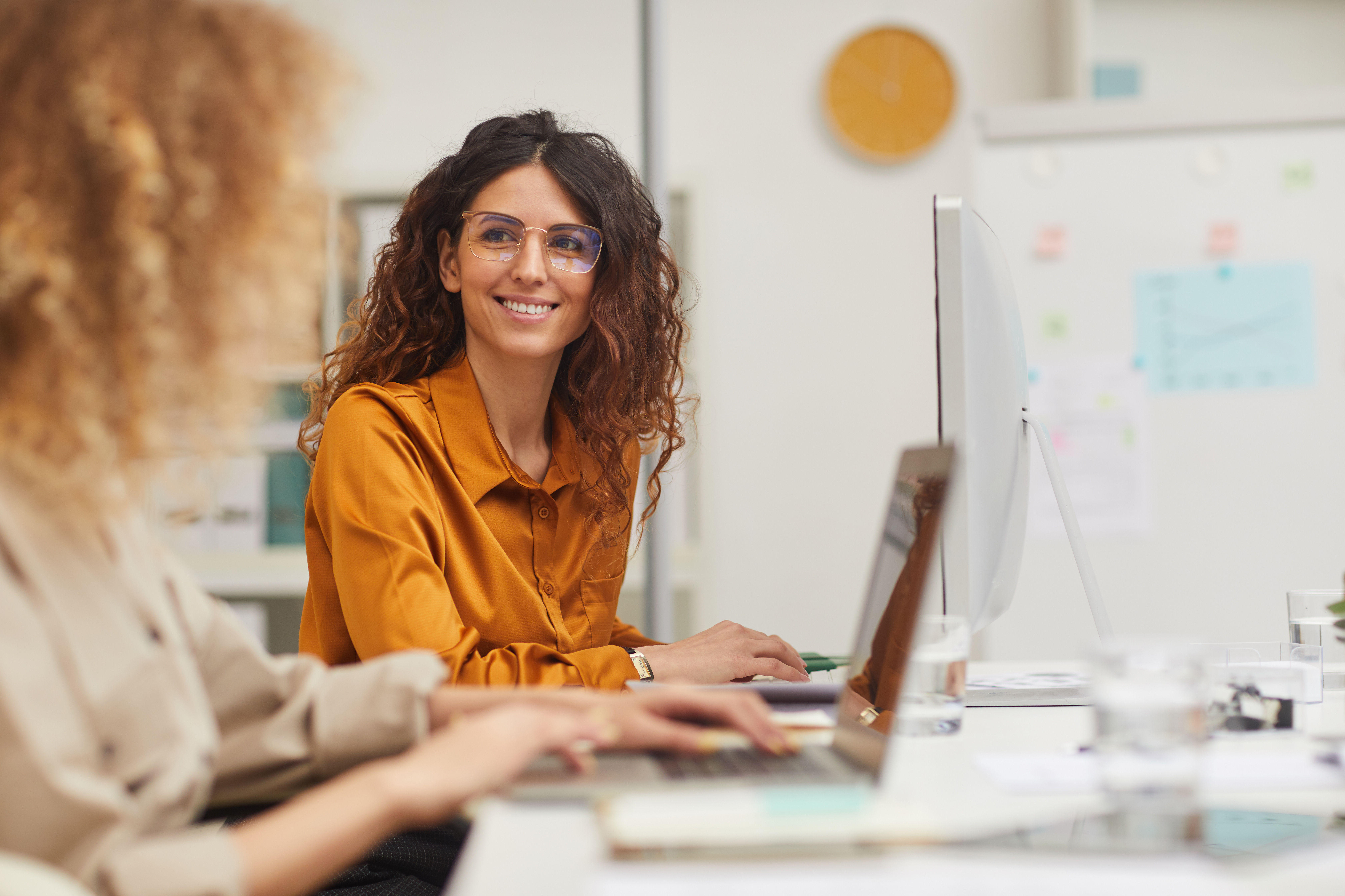 women-at-desk-in-orange.jpeg