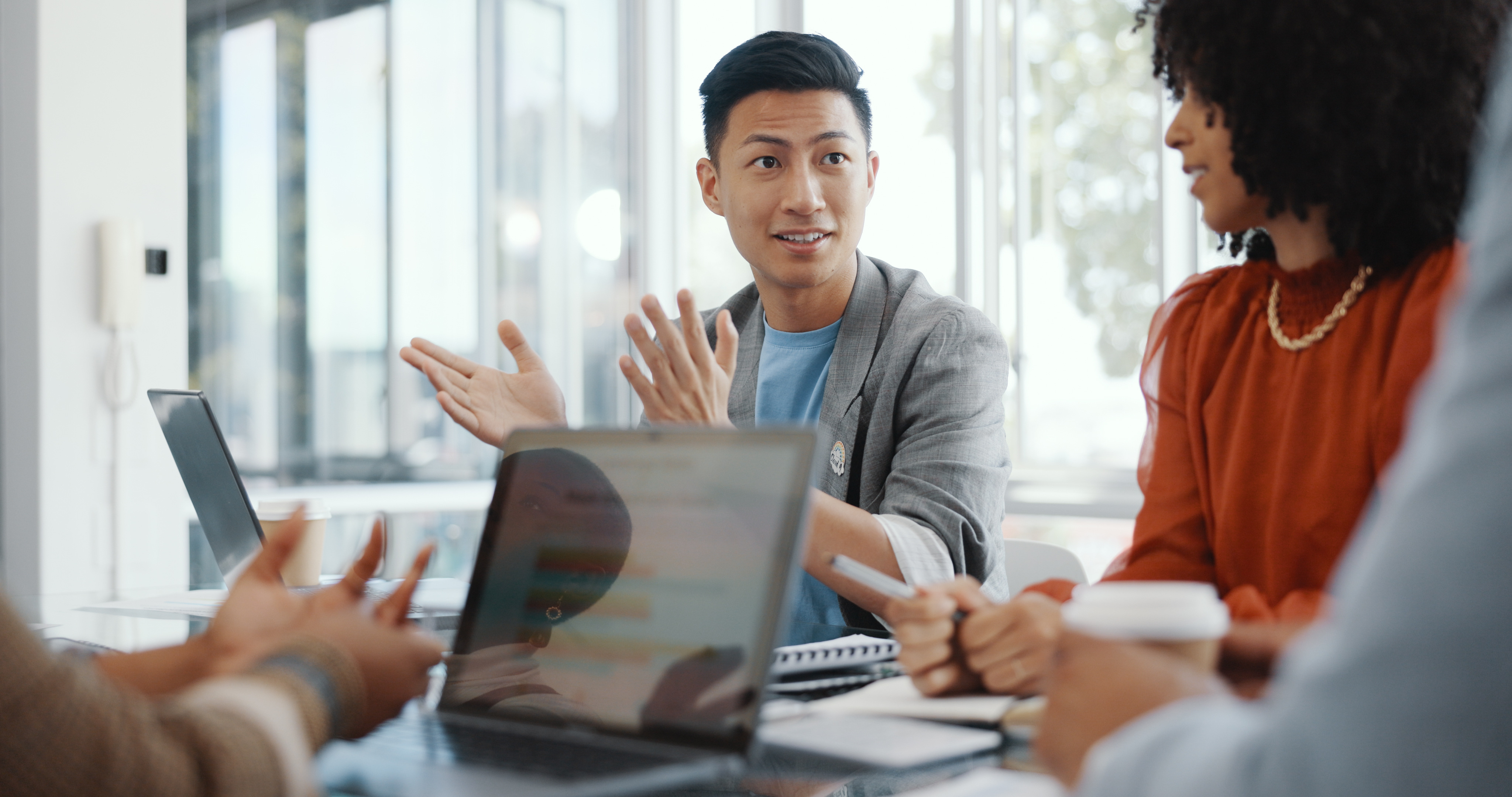 man-gesturing-while-presenting-to-colleagues-in-meeting.jpeg