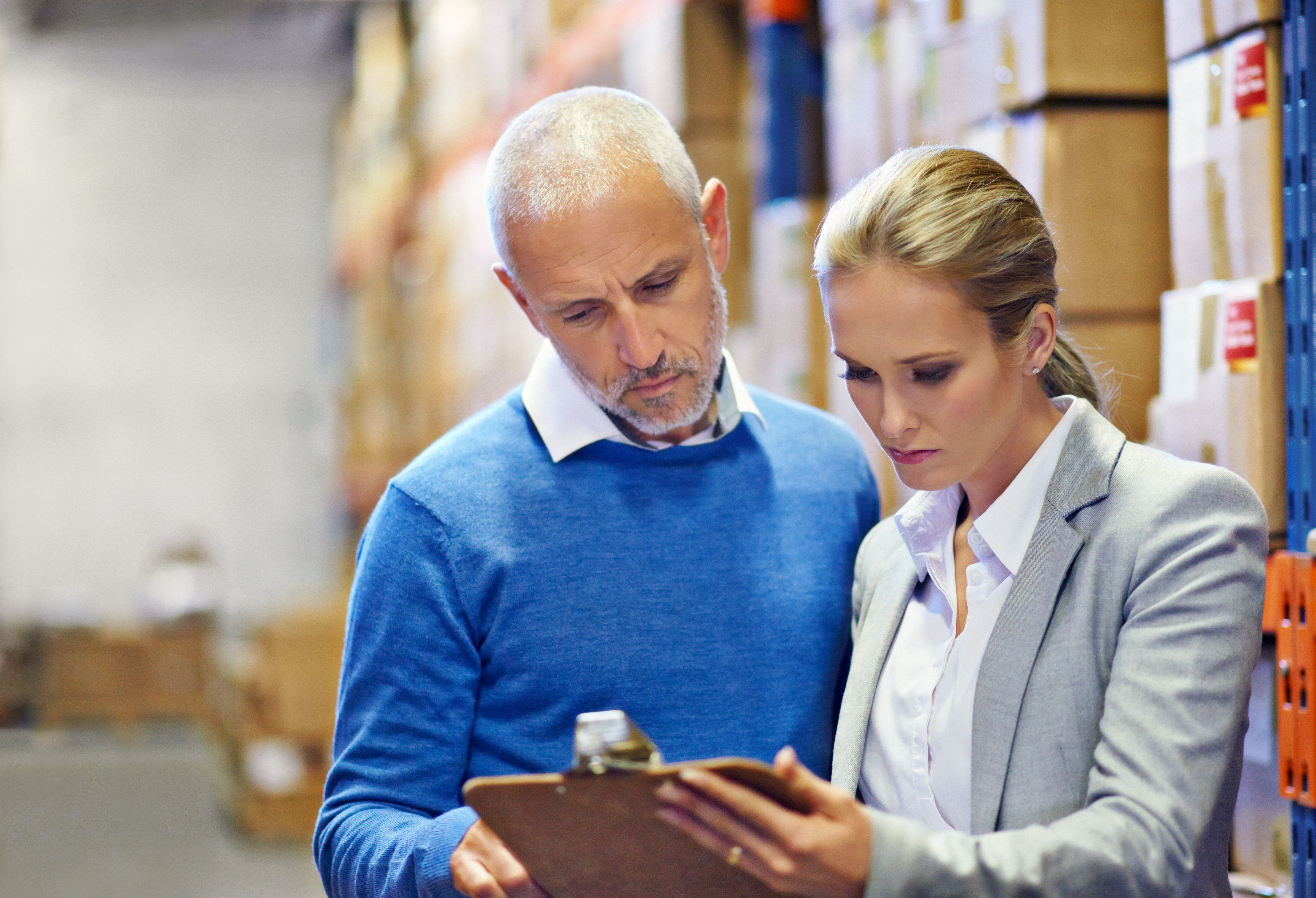 man-and-woman-reviewing-clipboard-in-warehouse.jpeg