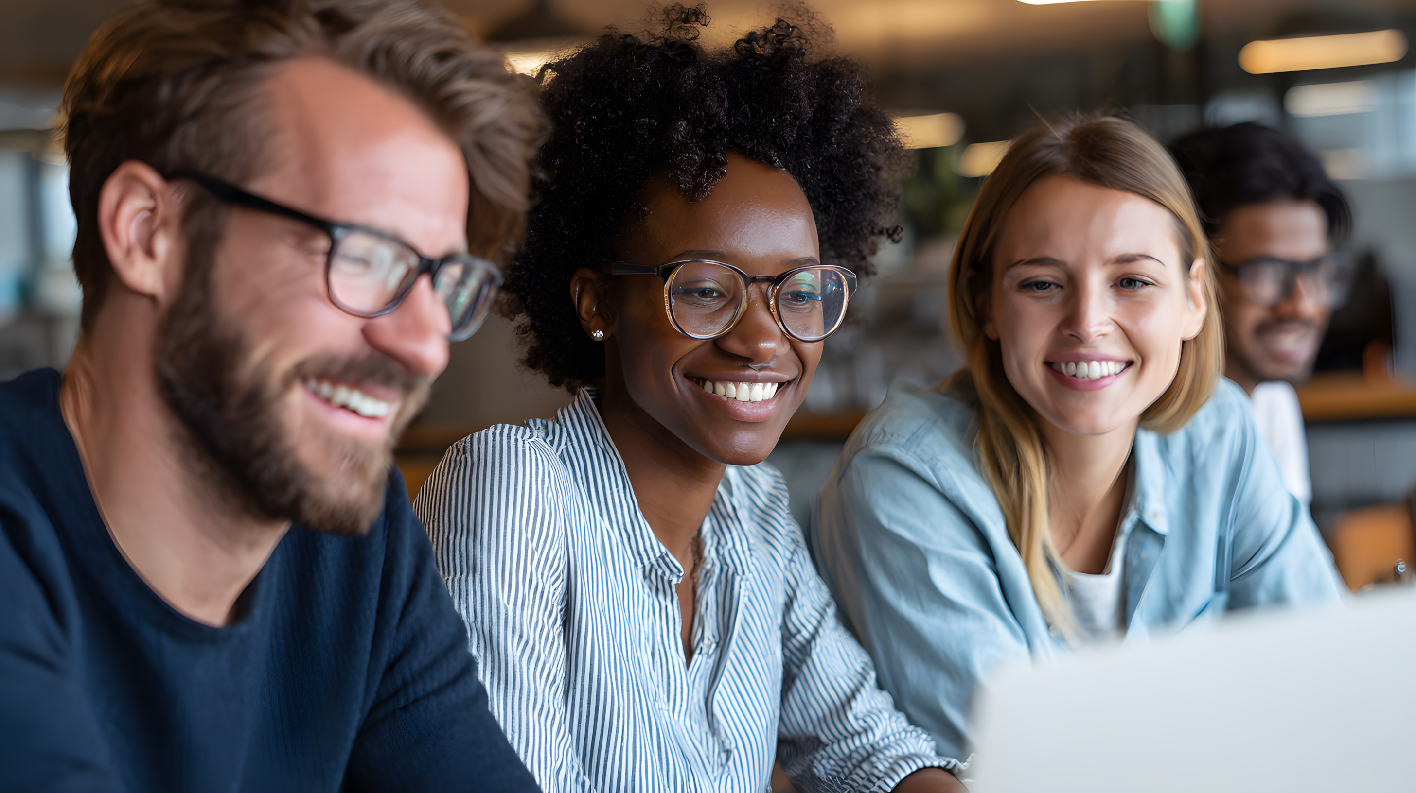 diverse-colleagues-smiling-and-laughing-together-in-office.jpeg